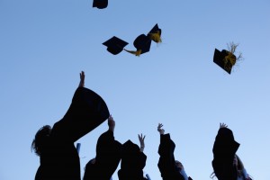Students throw hats in air Students throw their mortarboards in the air